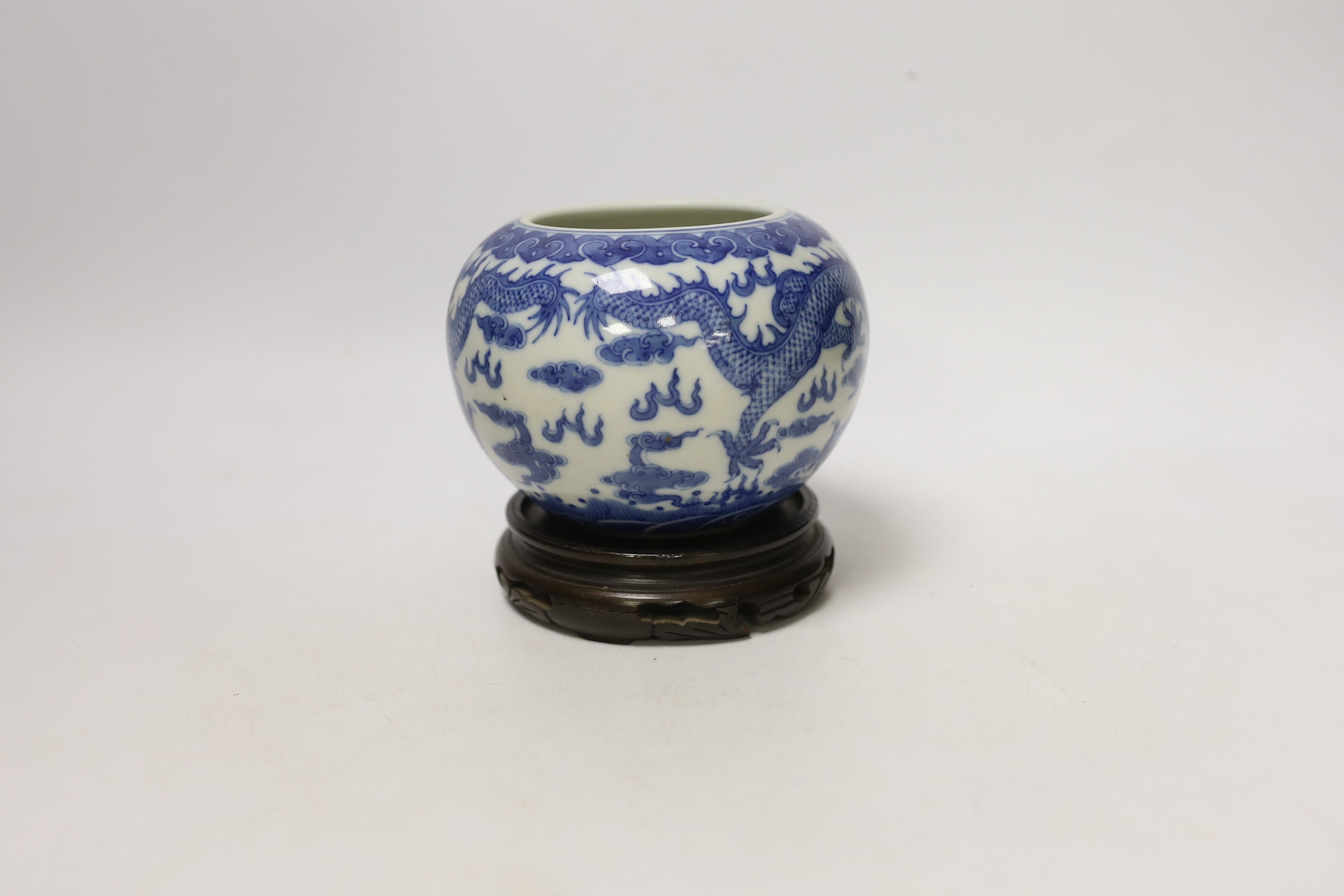 A Chinese blue and white dragon water pot on stand, bowl 12.5cm high including stand
